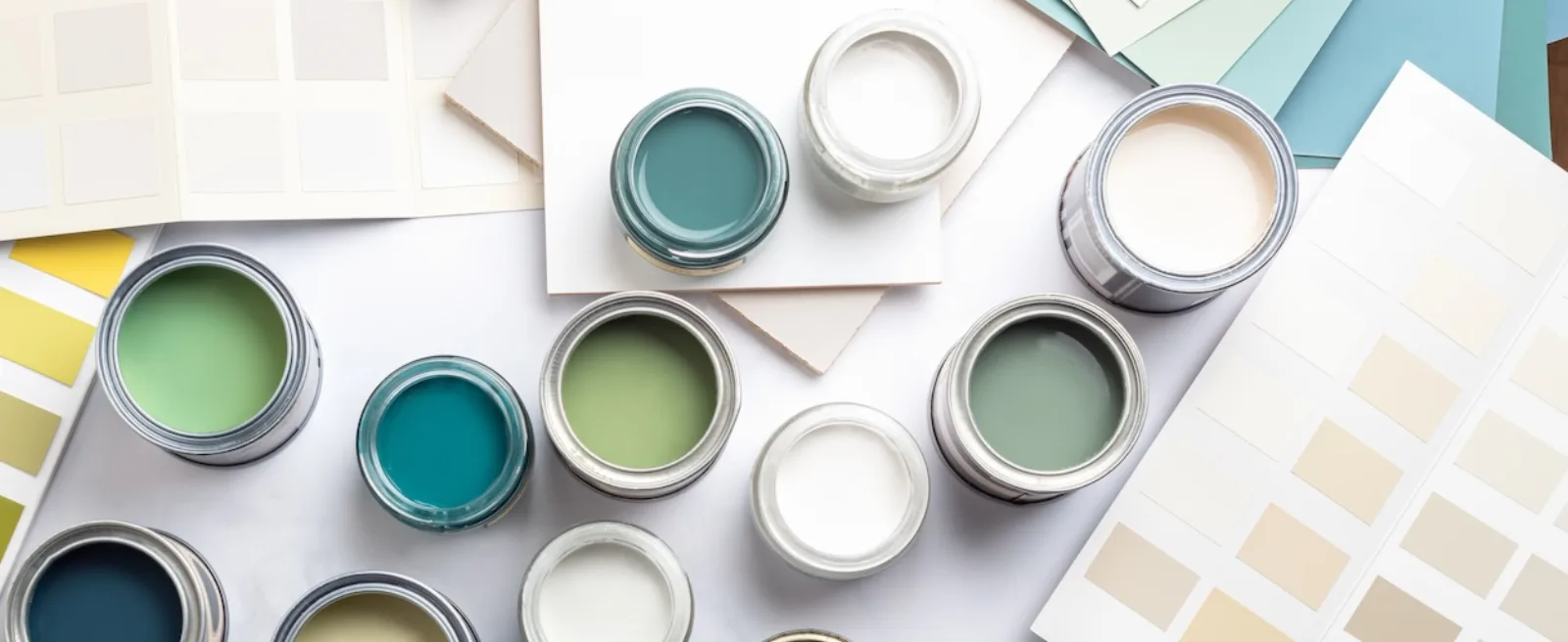Paint cans and color cards arranged on a table