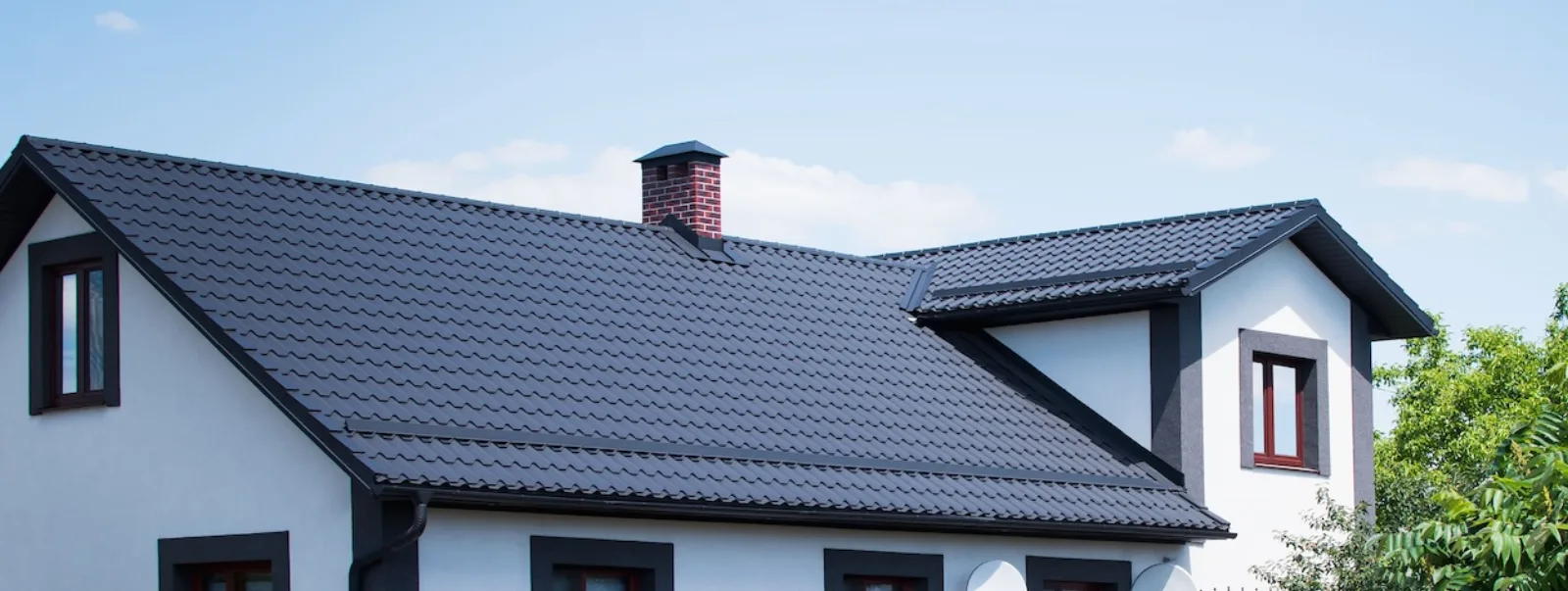 White house with a dark shingled roof