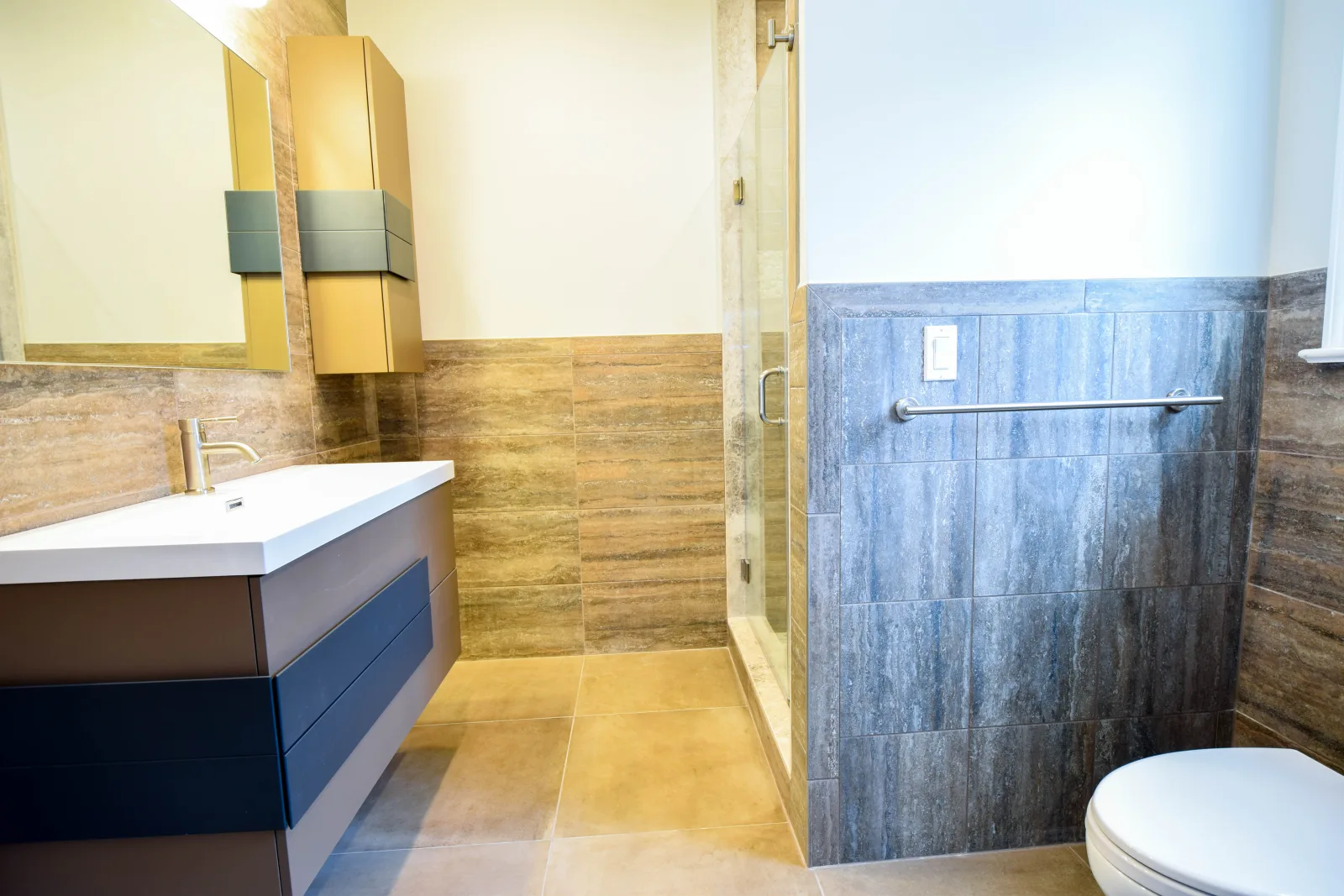 Floating vanity beside a tiled walk in shower