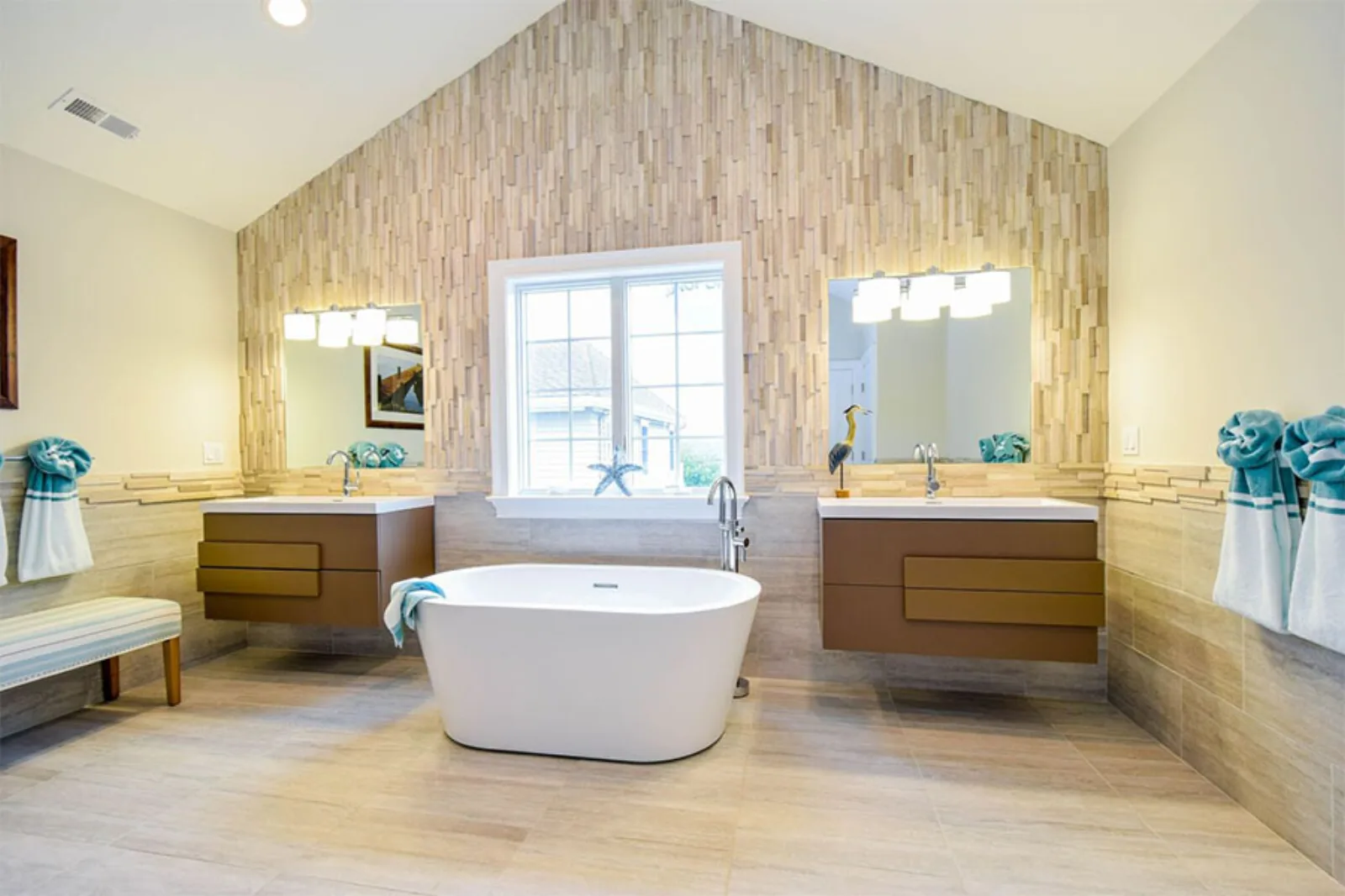 Spa bathroom with a freestanding tub and two wood vanities