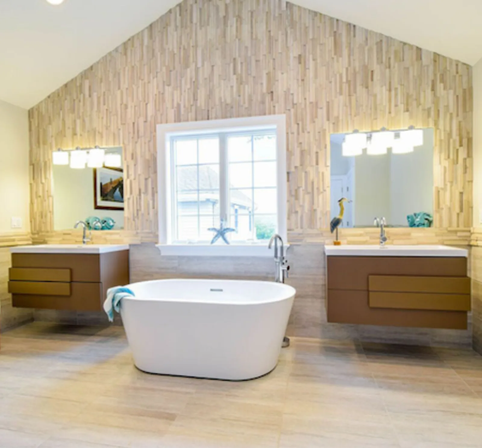 Bathroom with a freestanding tub, wood look tile and double vanity