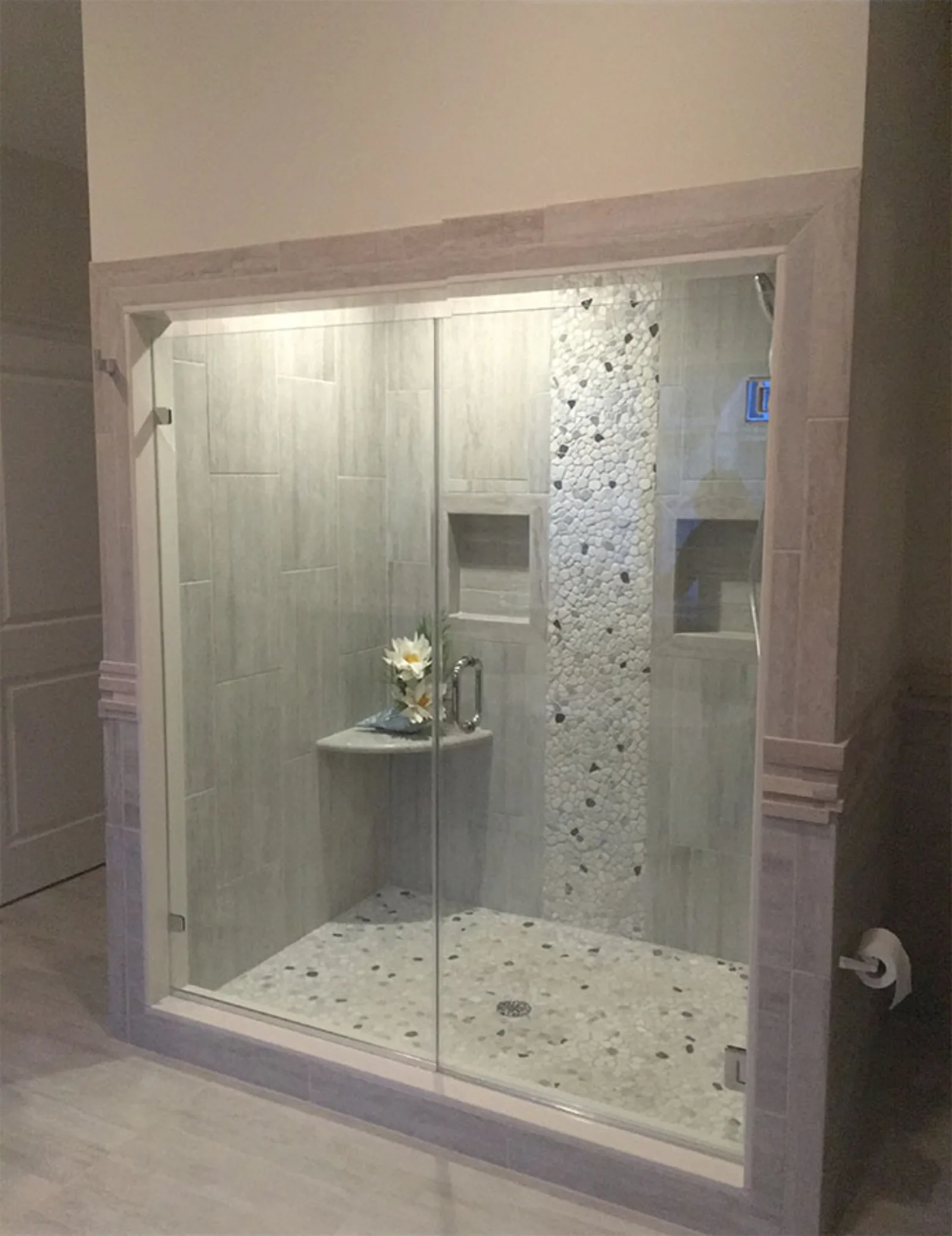 Walk in shower with a mosaic tile accent band