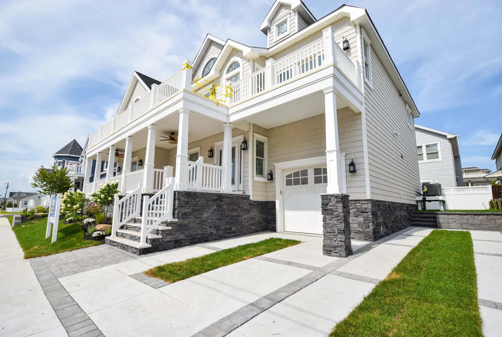 New two story home with a full front porch and stone accents
