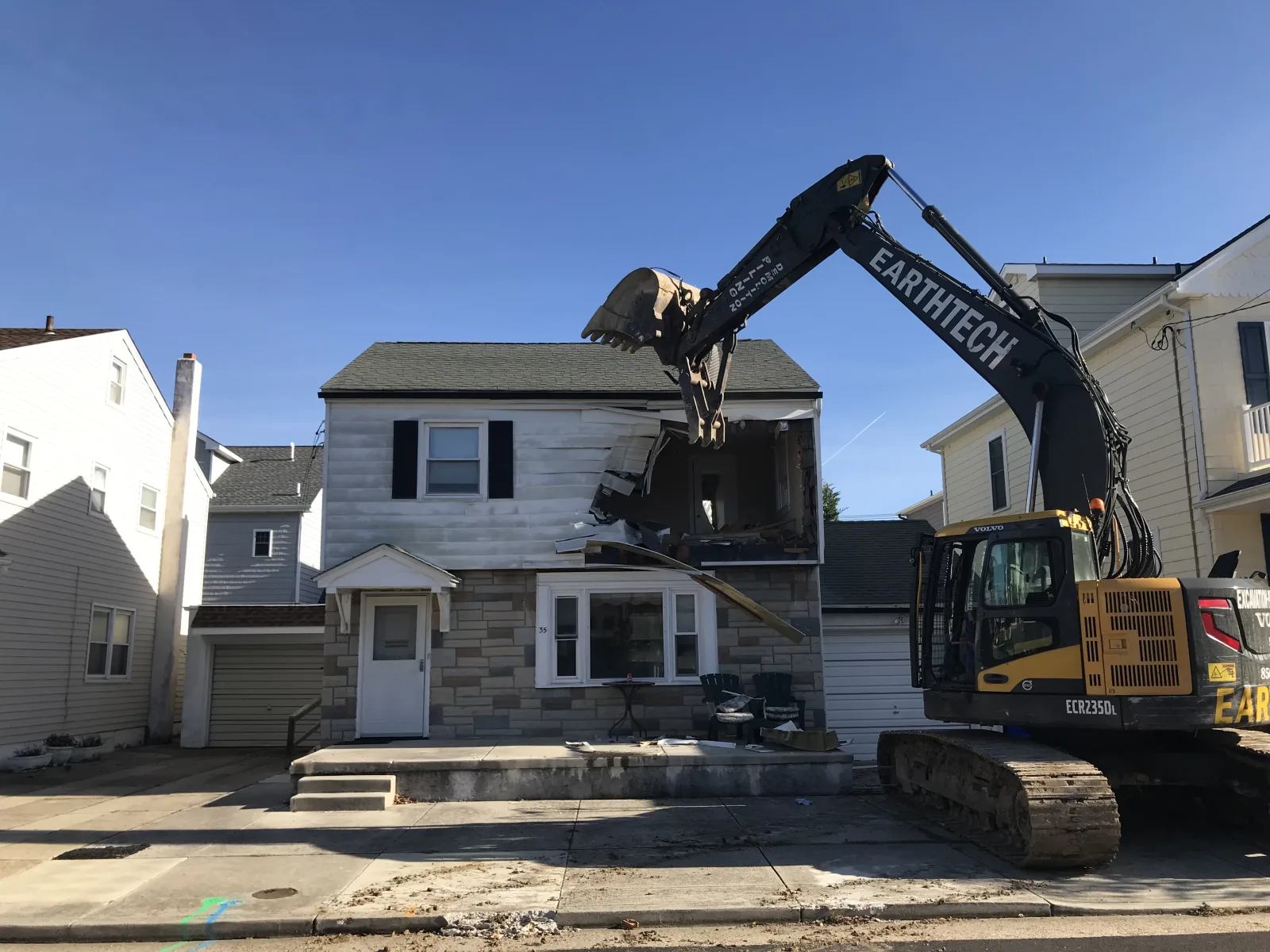 Excavator taking down a house during demolition
