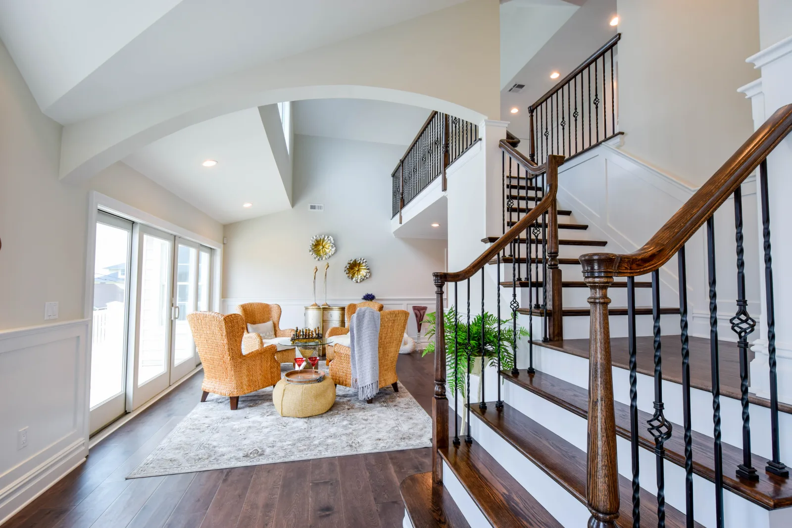 Foyer with a turned staircase and a bright sitting area