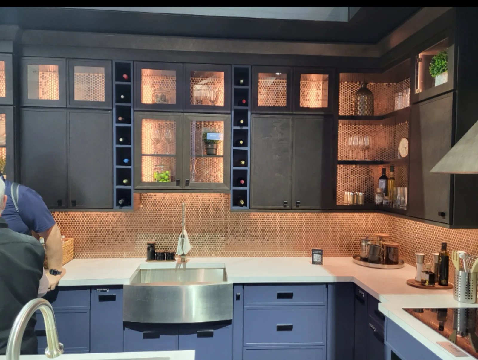 Kitchen with a copper backsplash and a stainless farm sink