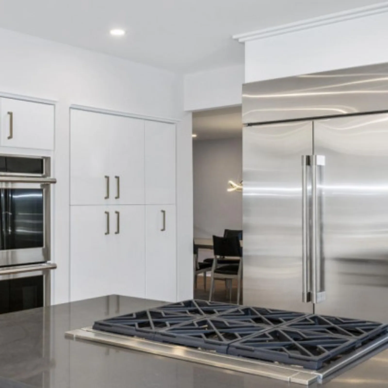 Tall white cabinetry with an integrated refrigerator