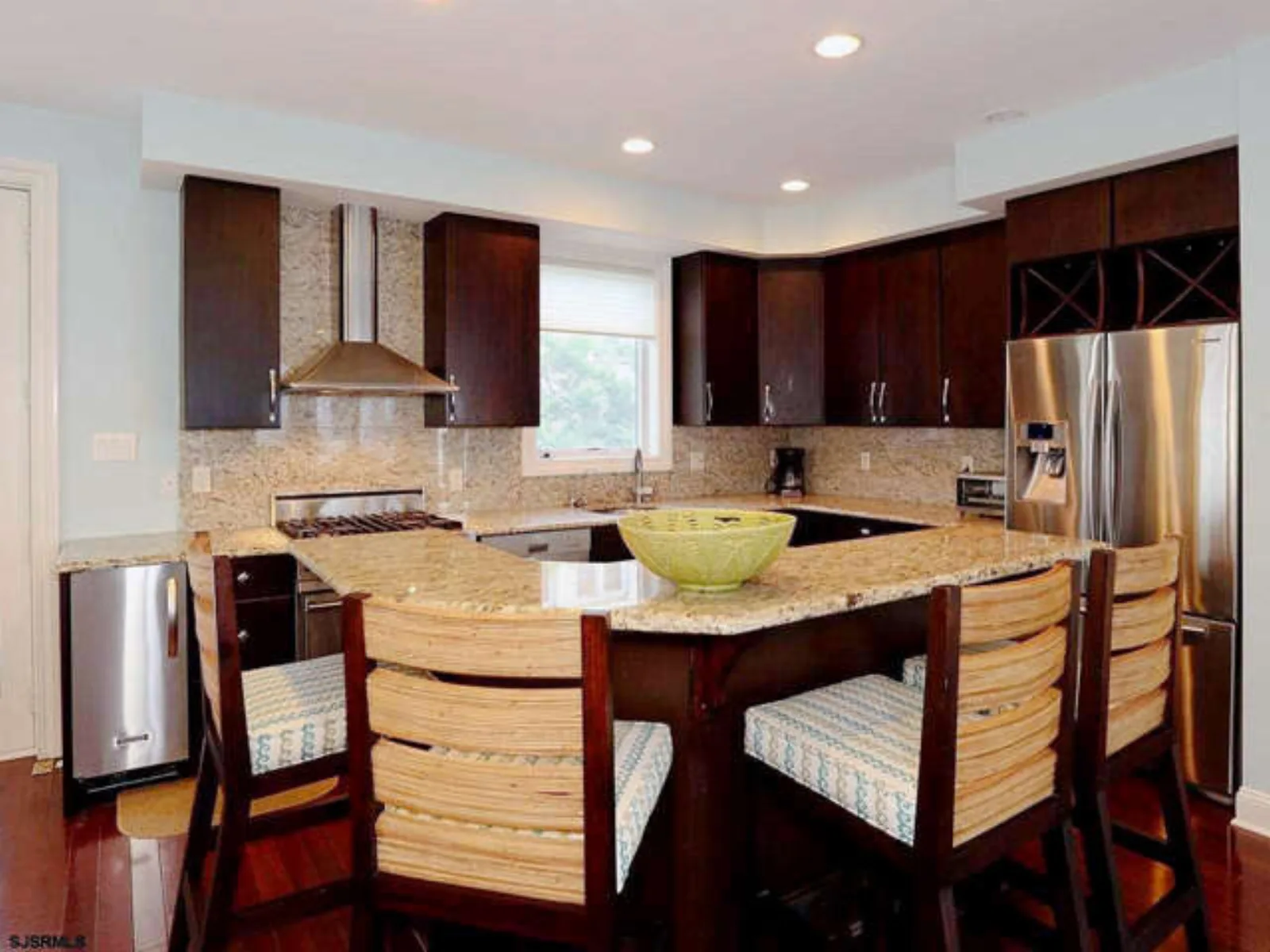 Traditional cherry kitchen with a granite topped island