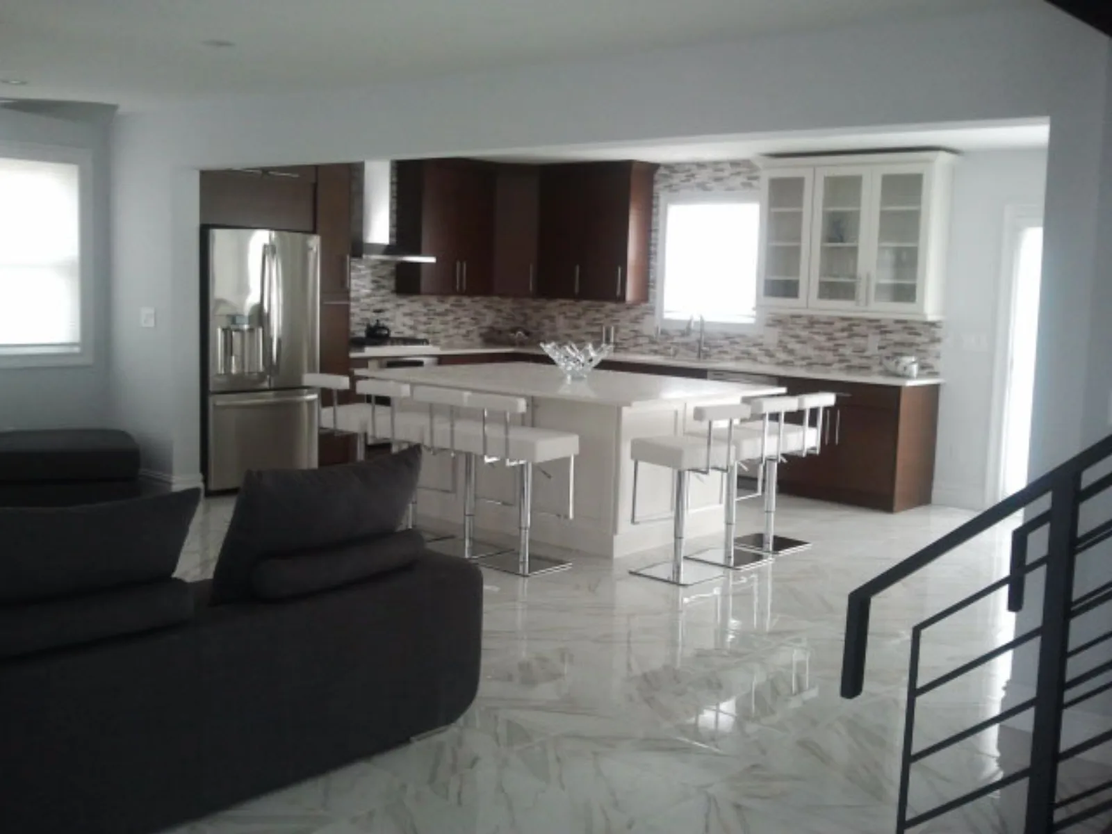Open plan kitchen and living space with marble tile flooring