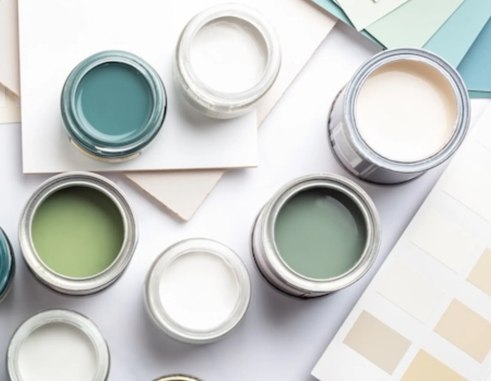 Open paint cans and swatches laid out for color selection