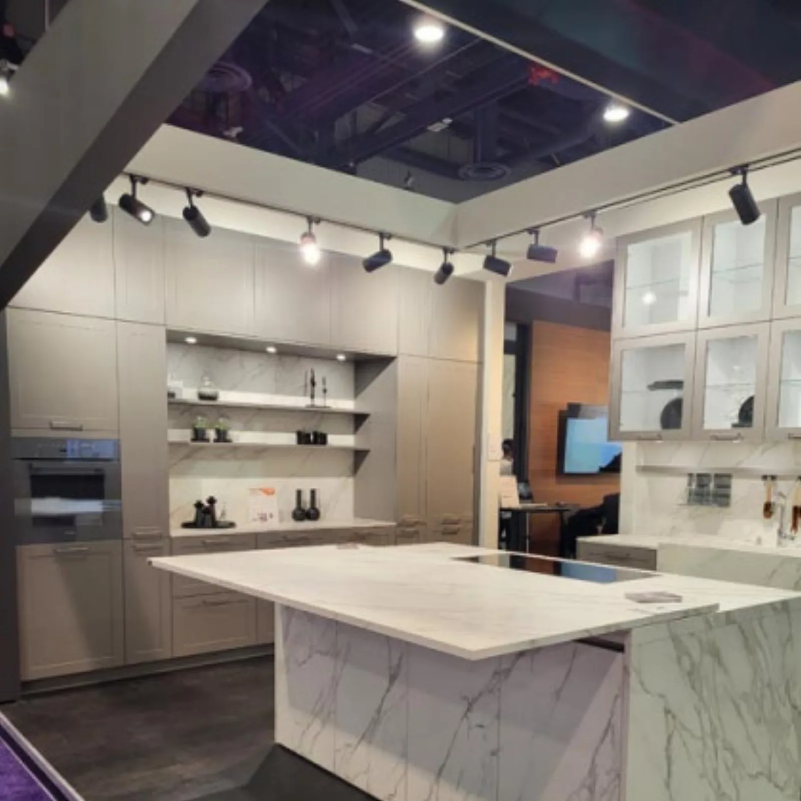 Showroom display island with a marble waterfall edge